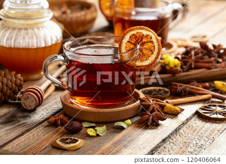 Herbal tea with cinnamon, anise, dried herbs, and dry citrus slices. Herbal tea with cinnamon, anise, dried herbs, and dry citrus slices. 120406064