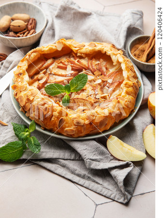 Delicious homemade apple galette with almond flakes and cinnamon 120406424