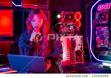 Software engineer typing coding in laptop computer at data center, Hacker woman is sitting at a desk with a laptop service in server room, Thinking and solve problems, Cyber security 120406999