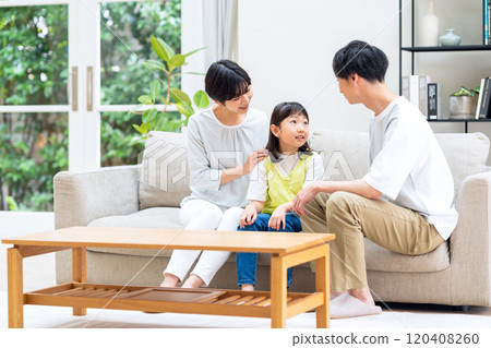 A family relaxing in the living room 120408260