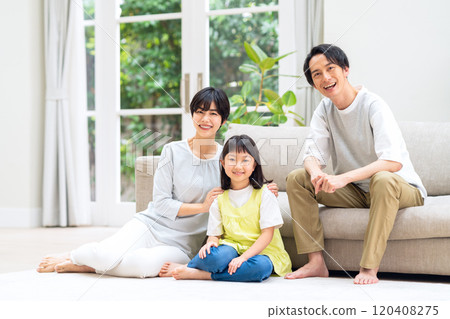 A family relaxing in the living room 120408275