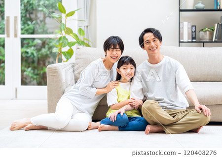 A family relaxing in the living room 120408276