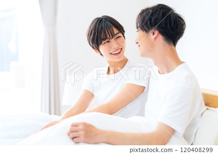 Young couple relaxing in the bedroom Young couple relaxing in the bedroom 120408299