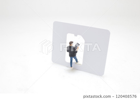 Miniature Man Reading Newspaper Inside a Credit Card Frame Miniature Man Reading Newspaper Inside a Credit Card Frame 120408576