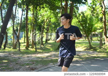 Young asian man enjoying a morning run in nature. Wellness and Healthy lifestyle concept 120408994