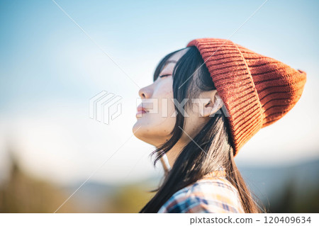 young woman looking up at the sky young woman looking up at the sky 120409634
