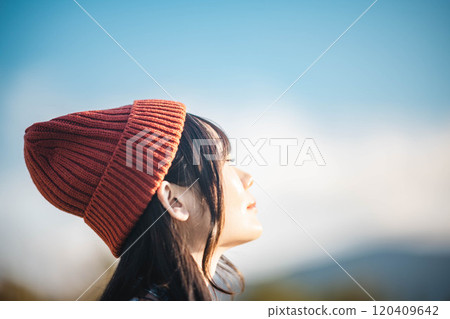 young woman looking up at the sky young woman looking up at the sky 120409642