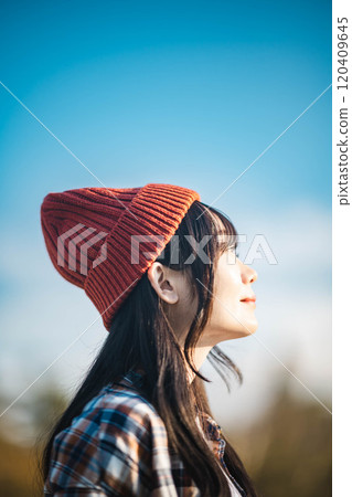 young woman looking up at the sky 120409645