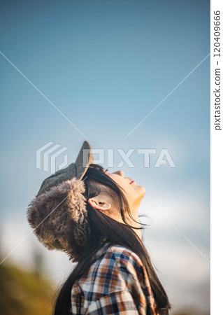 young woman looking up at the sky 120409666