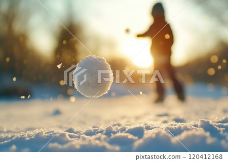 Snowball Toss on Snowy Ground with Sunlight Reflection 120412168