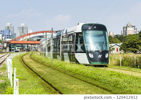 The circular light rail train drives past Hamasen Railway Cultural Park in Kaohsiung, Taiwan. 120412912