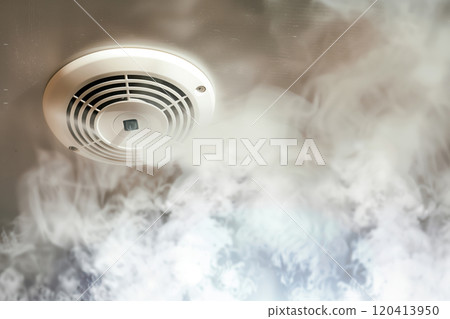Smoke detector amid fire and smoke 120413950