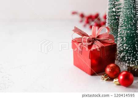 Red gift box on white marble background. Christmas New year concept. Selective focus. Red gift box on white marble background. Christmas New year concept. Selective focus. 120414595