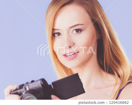 Blonde woman with camera on blue Blonde woman with camera on blue 120416662
