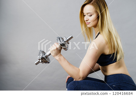 Fit woman lifting dumbbells weights Fit woman lifting dumbbells weights 120416684