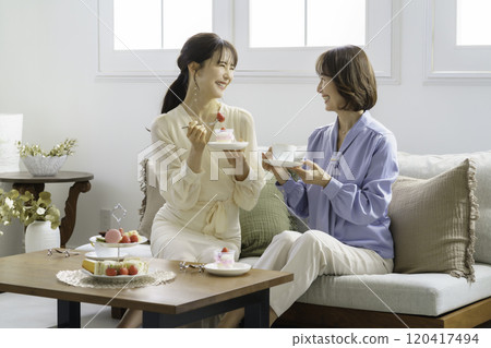 A daughter in her 30s having tea in a hotel tea room and her mother receiving it A daughter in her 30s having tea in a hotel tea room and her mother receiving it 120417494