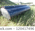 An old tank abandoned in the grass 120417496