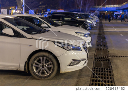 row of cars parked in front of airport at night 120418462