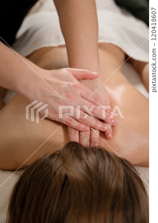 Therapist performing back massage with hands on a relaxed patient. Wellness and relaxation concept Therapist performing back massage with hands on a relaxed patient. Wellness and relaxation concept 120418607