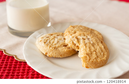 Thanking Santa with cookies and milk - Santa Claus takes a bite of a cookie - Christmas Thanking Santa with cookies and milk - Santa Claus takes a bite of a cookie - Christmas 120418914