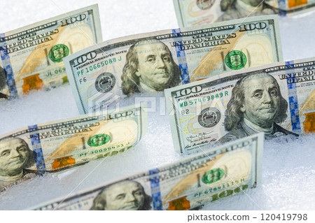 us dollar banknotes standing on their side on the snow surface at sunny winter day us dollar banknotes standing on their side on the snow surface at sunny winter day 120419798