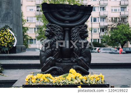 Monument adorned with flowers and daffodils, commemorating the Warsaw Ghetto Uprising Monument adorned with flowers and daffodils, commemorating the Warsaw Ghetto Uprising 120419922
