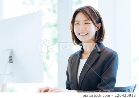 A woman working in a bright office 120420918