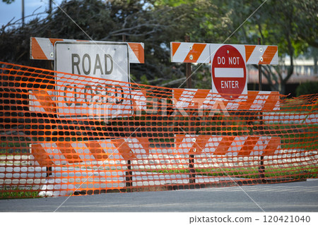Yellow protective fence barrier at street construction site. Warning road sign about utility work Yellow protective fence barrier at street construction site. Warning road sign about utility work 120421040