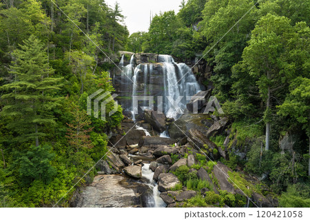 Whitewater Falls in Nantahala National Forest, North Carolina, USA. Beautiful landscape of high waterfall with falling down clear water from rocky boulders between green lush woods Whitewater Falls in Nantahala National Forest, North Carolina, USA. Beautiful landscape of high waterfall with falling down clear water from rocky boulders between green lush woods 120421058