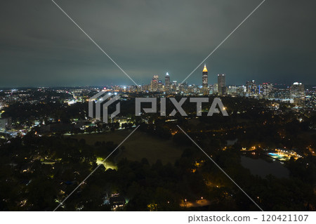 View from above of brightly illuminated high skyscraper buildings in downtown district of Atlanta city in Georgia, USA. American megapolis with business financial district at night 120421107