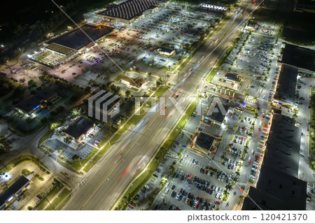 Strip mall plaza in North Port, Florida with illuminated traffic driving cars. USA transportation infrastructure concept 120421370