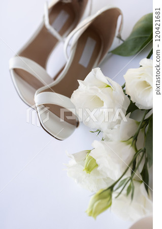 White wedding shoes with white flowers. White wedding shoes with white flowers. 120421681