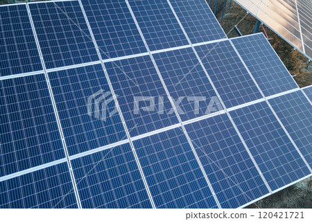 Solar photovoltaic panels for producing of clean ecological electrical energy mounted on backyard ground in suburban rural area. Concept of autonomous home 120421721