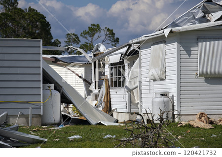 Severely damaged houses after hurricane Ian in Florida mobile home residential area. Consequences of natural disaster 120421732