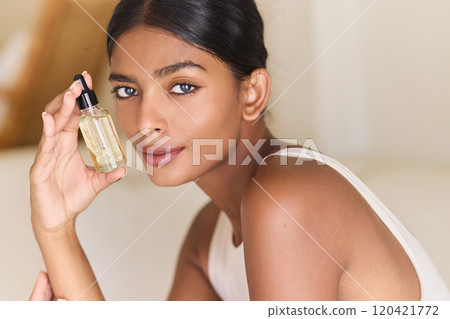 Woman Holding Skincare Serum Bottle With Natural Radiant Glow Woman Holding Skincare Serum Bottle With Natural Radiant Glow 120421772