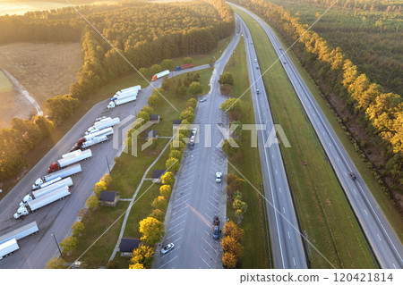 Parking rest area for cargo tractor-trailers near American interstate freeway. Resting place during interstate goods hauling in USA 120421814