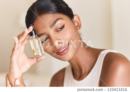 Woman Holding Skincare Serum Bottle With Radiant Smile And Glowing Skin Woman Holding Skincare Serum Bottle With Radiant Smile And Glowing Skin 120421818