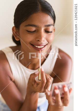 Woman Applying Lip Gloss for Smooth and Hydrated Lips Woman Applying Lip Gloss for Smooth and Hydrated Lips 120421821