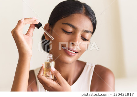 Woman Applying Facial Oil for Skincare Routine and Glowing Skin Woman Applying Facial Oil for Skincare Routine and Glowing Skin 120421917