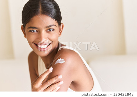 Radiant Woman Applying Skincare Cream Smiling With Natural Beauty Radiant Woman Applying Skincare Cream Smiling With Natural Beauty 120421942
