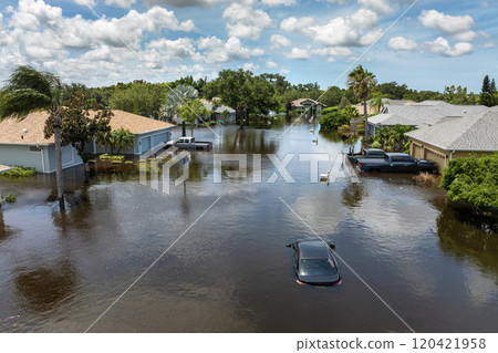 Hurricane rainfall flooded road. Drowned car on city street in Florida residential area. Consequences of hurricane natural disaster Hurricane rainfall flooded road. Drowned car on city street in Florida residential area. Consequences of hurricane natural disaster 120421958