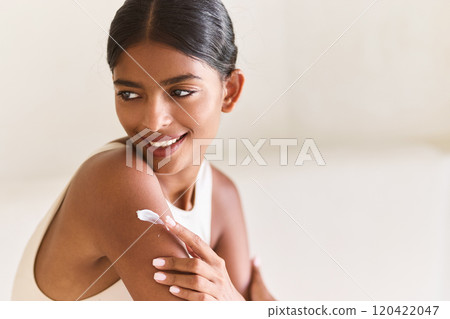 Cream Woman Applying Skincare Lotion Smiling Confidently with Radiant Skin Cream Woman Applying Skincare Lotion Smiling Confidently with Radiant Skin 120422047