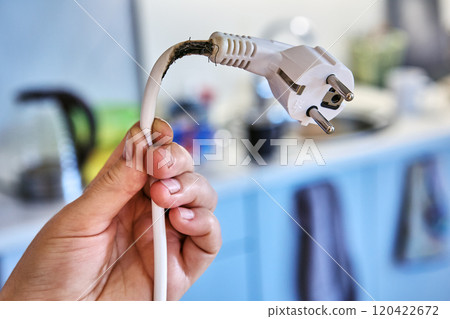 Extension cord burned out when overloaded by powerful electrical appliance. 120422672