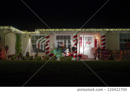Front yard with brightly illuminated christmas decorations. Outside decor of florida family home for winter holidays 120422700