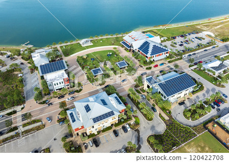 Florida office buildings with solar roof in small autonomous town. Blue photovoltaic panels for producing clean ecological electric energy. Investing in renewable electricity concept 120422708