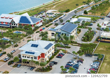 Florida office buildings with solar roof in small autonomous town. Blue photovoltaic panels for producing clean ecological electric energy. Investing in renewable electricity concept 120422709