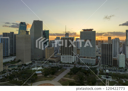 Evening urban landscape of downtown district of Miami Brickell in Florida USA. Skyline with dark high skyscraper buildings and street with cars and Metrorail traffic in modern american megapolis Evening urban landscape of downtown district of Miami Brickell in Florida USA. Skyline with dark high skyscraper buildings and street with cars and Metrorail traffic in modern american megapolis 120422773