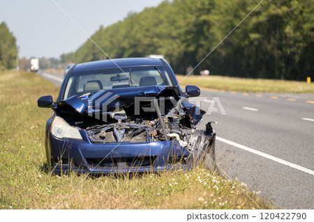 Dumped crashed car after traffic accident parked on highway roadside Dumped crashed car after traffic accident parked on highway roadside 120422790