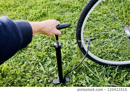 Inflating bicycle tire with air using floor pump with universal head equipped with lever clamp. 120422818
