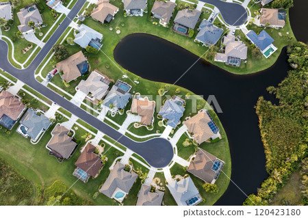 Cul de sac street dead end and private residential houses in rural suburban sprawl area in North Port, Florida. Upscale suburban homes with large waterfront backyards Cul de sac street dead end and private residential houses in rural suburban sprawl area in North Port, Florida. Upscale suburban homes with large waterfront backyards 120423180
